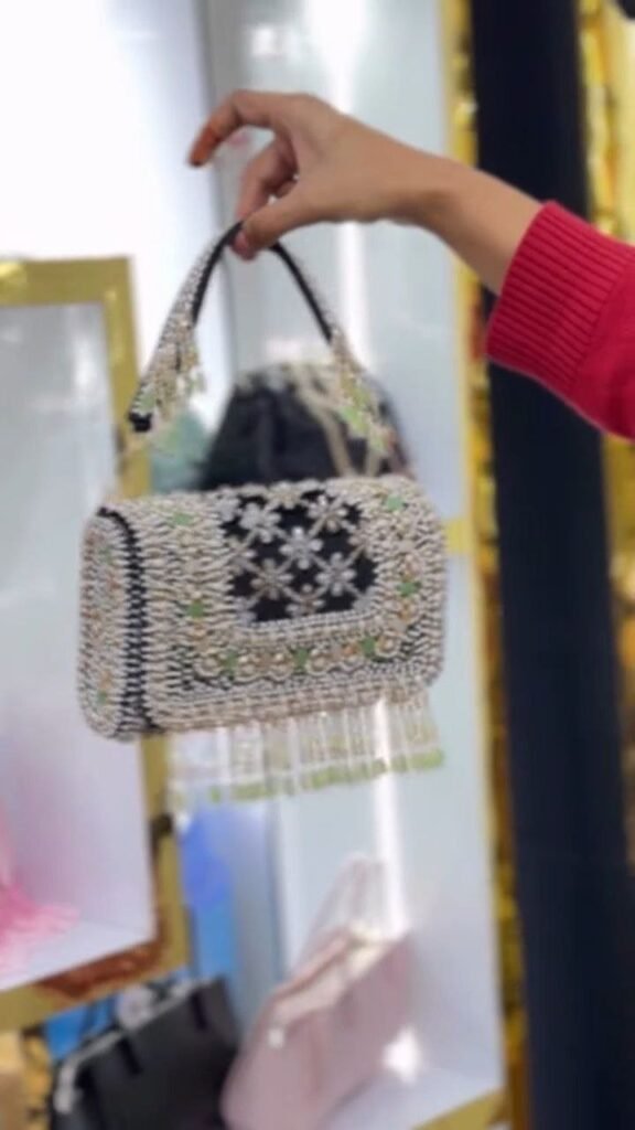 Pearl-Embellished Potli Handbag with Tassel Handle - Photo 1